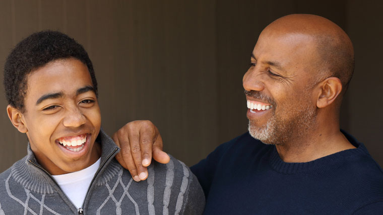 A father and son laugh together while enjoying a special moment.