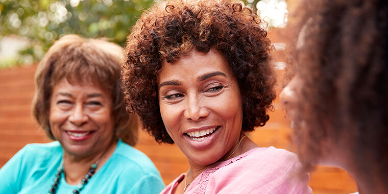 three women discuss earlier breast cancer screenings, like mammograms