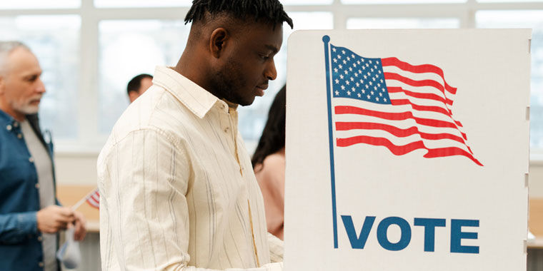 Man votes at an American voting booth overcoming election anxiety