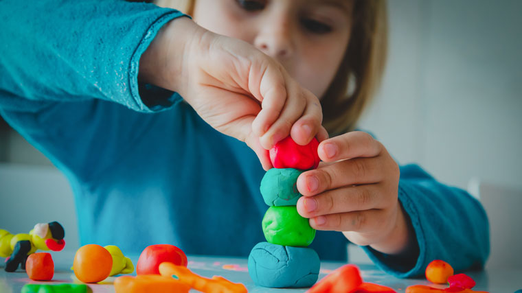 Chid playing with Play-Doh