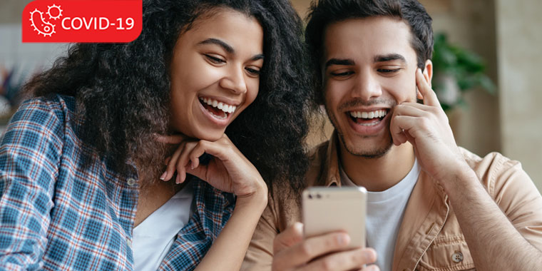 Couple watching something together on a fun, laughing