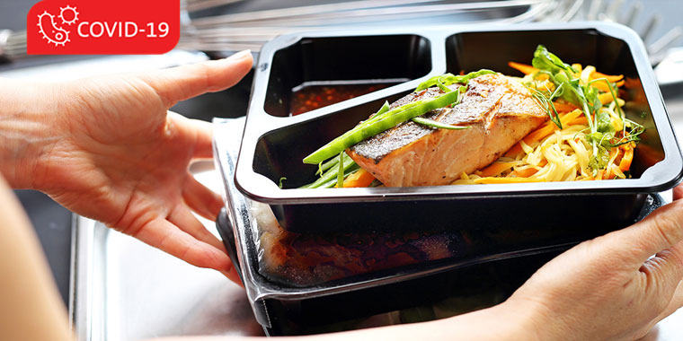 Box of take-out food with salmon and vegetables