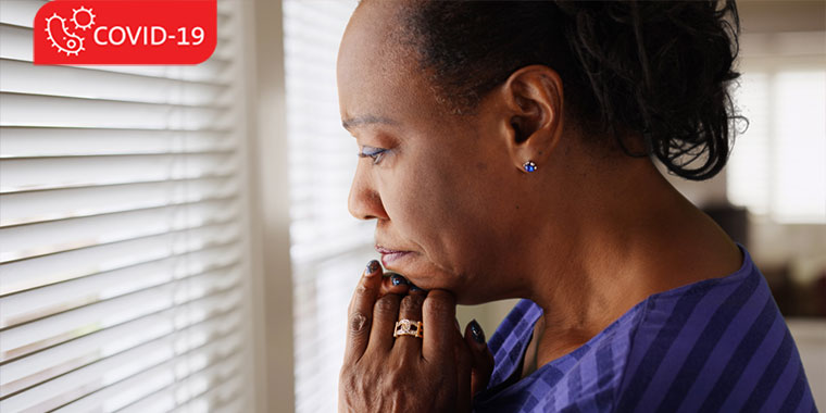 Woman grieving, staring out a window