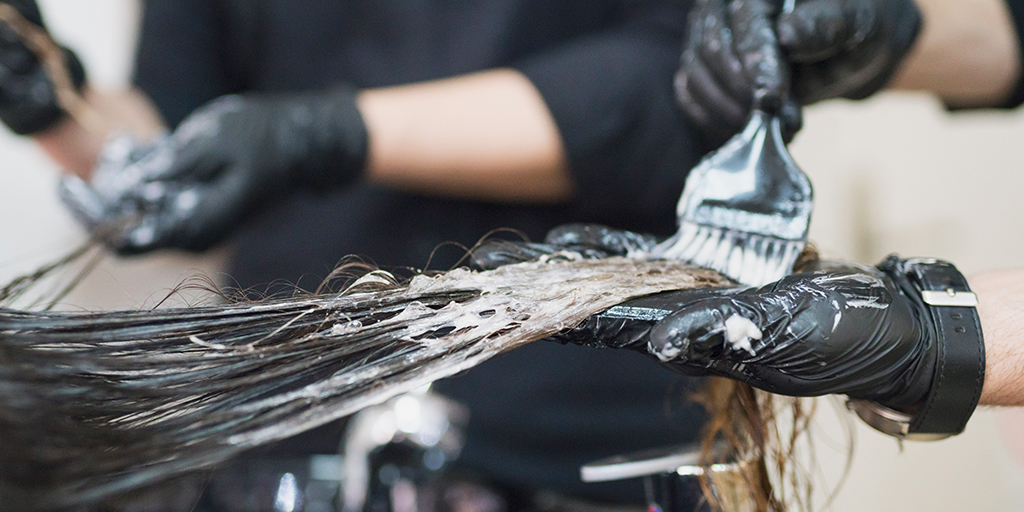 Stylist putting hair dye on hair