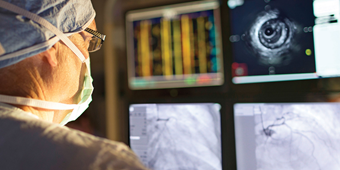 A cardiologist studies heart arrhythmia on screen