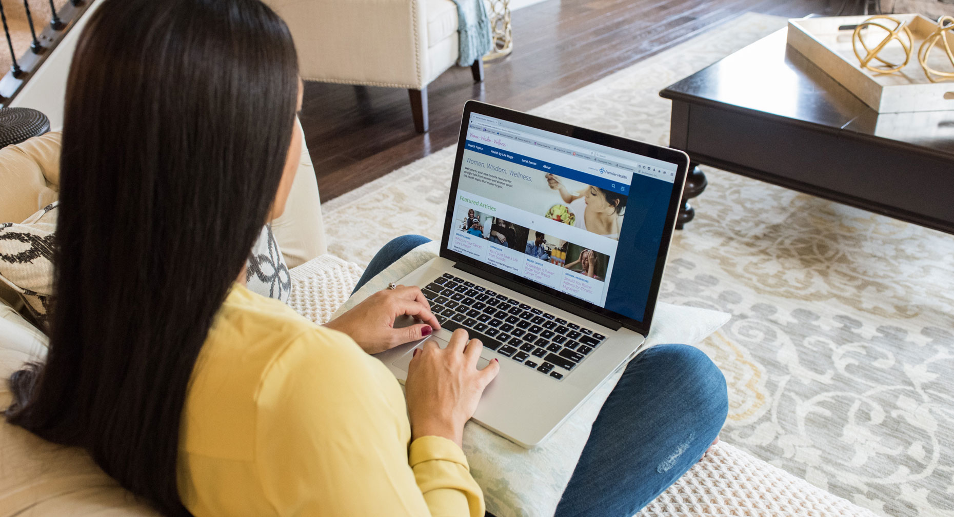 Woman reading an article on her laptop computer