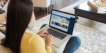 Woman reading an article on her laptop computer