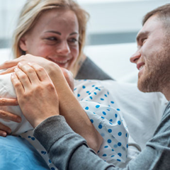 Couple greeting baby